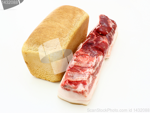 Image of Roll of fresh bread and the big piece 