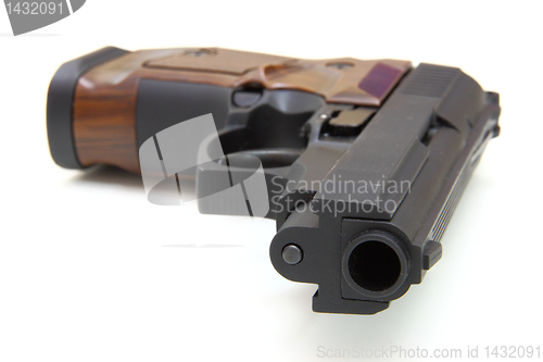 Image of The close up of a pistol a target and cartridges is isolated on 