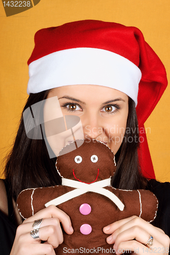 Image of Santa Claus girl with gingerbread man puppet