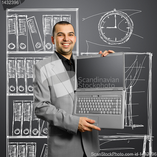 Image of businessman with open laptop in his hands