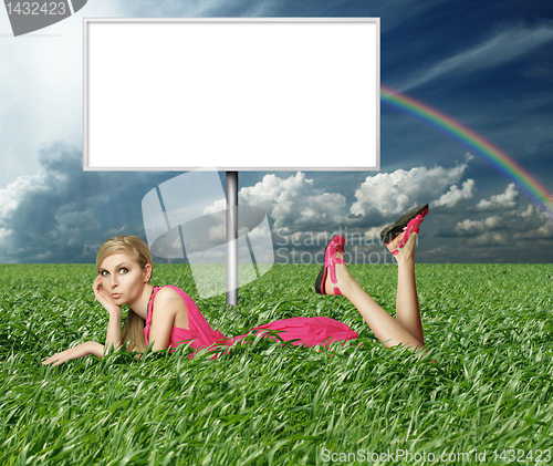 Image of Blonde in pink dress in green grass