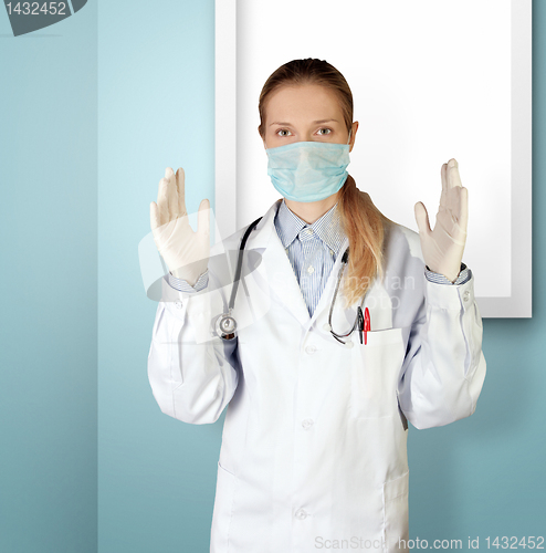 Image of doctor woman in mask looking at camera