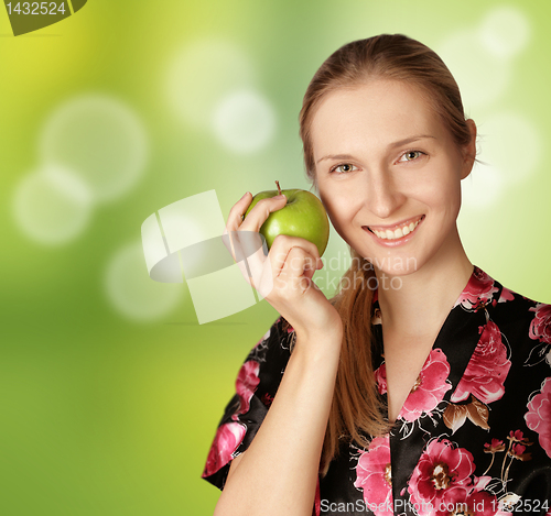 Image of happy woman with agreen apple