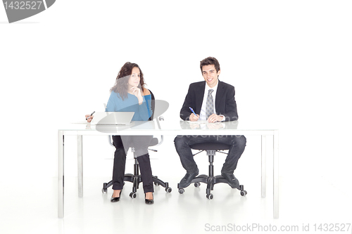 Image of Young girl and boy working at their desk 