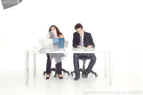 Image of girl and boy at their office busy working