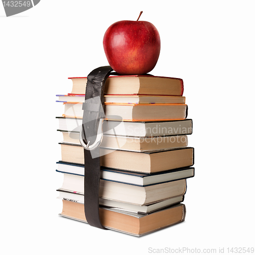 Image of books pile with belt and apple