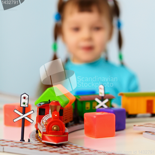 Image of Little girl with toy railroad