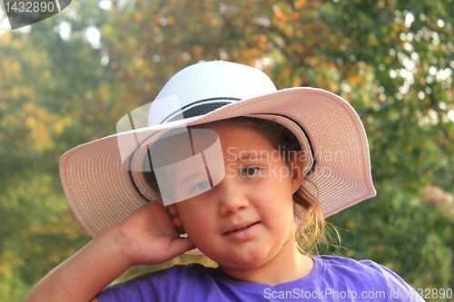 Image of Portrait of a pretty little girl in beige hat