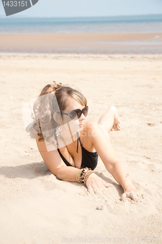 Image of laying on sand