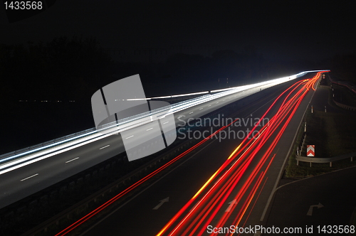 Image of road with car traffic at night with blurry lights