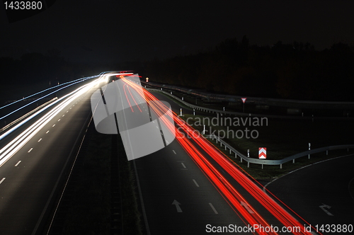 Image of road with car traffic at night with blurry lights