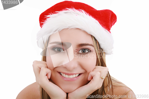 Image of Picture of pretty christmas girl in santa hat, smiling isolated 