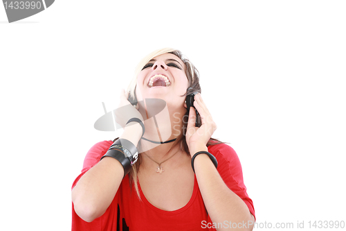 Image of Young woman with a cool rocker style listening to music 