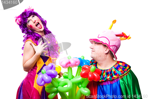 Image of loving clowns with colorful flowers