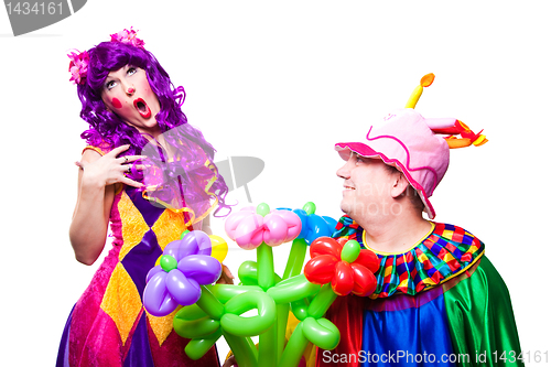 Image of loving clowns with colorful flowers