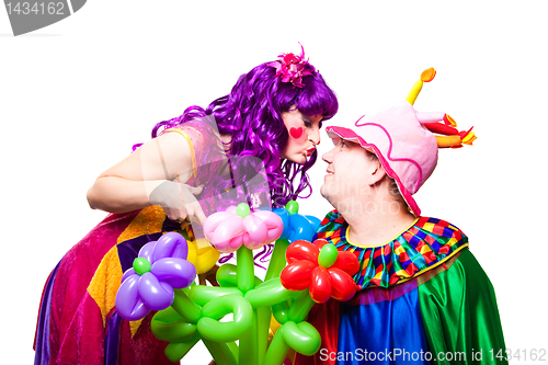 Image of loving clowns with colorful flowers