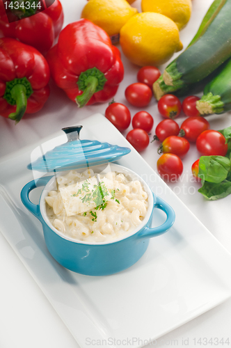 Image of mac and cheese on a blue little clay pot