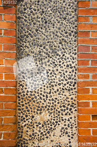 Image of Wall made of brick and concrete with little stones