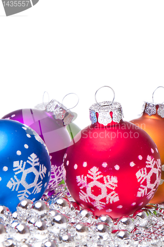 Image of christmas balls with snowflake symbols