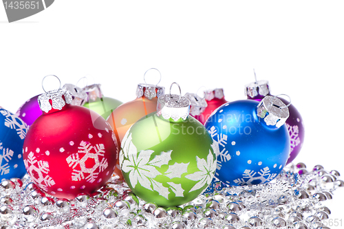 Image of christmas balls with snowflake symbols