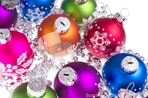 Image of christmas balls with snowflake symbols