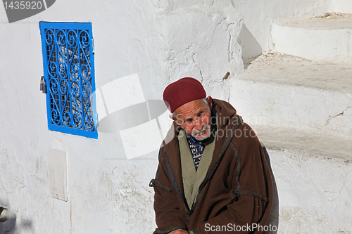 Image of The old man sitting on the stairs