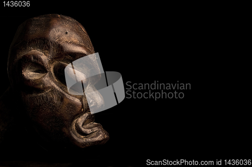 Image of African mask over black background