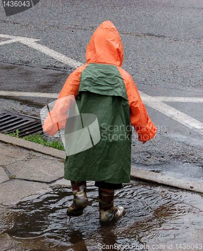 Image of Boy play in rain.