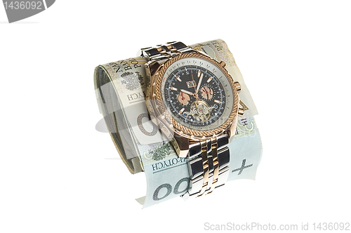 Image of Luxury gold watch around polish banknotes