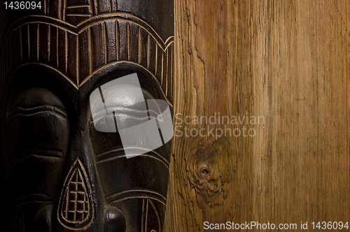 Image of African mask over wooden background