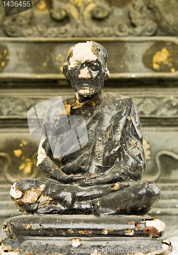 Image of weathered monk statue