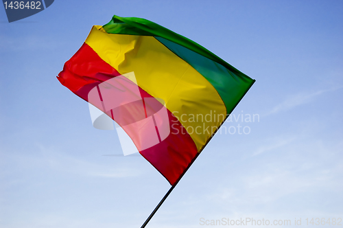 Image of reggae flag over blue sky