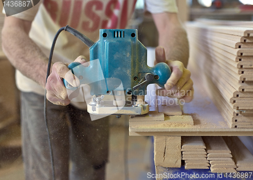 Image of Carpentry. Carpenter working in his workshop