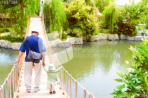 Image of father and son on bridge