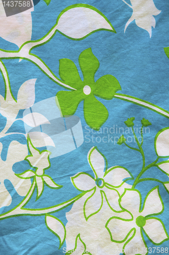 Image of Cotton material with leaf and flower patterns.
