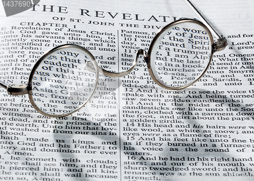 Image of Antique reading glasses on page of bible