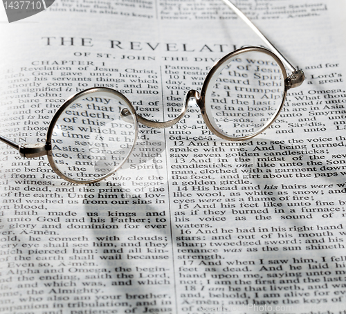 Image of Antique reading glasses on page of bible