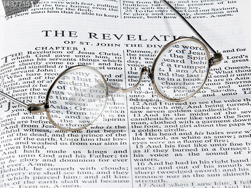 Image of Antique reading glasses on page of bible