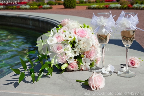 Image of wedding bouquet of tbride and  glasses of champagne