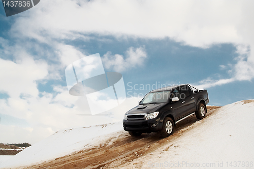 Image of Pickup truck driving down the hill