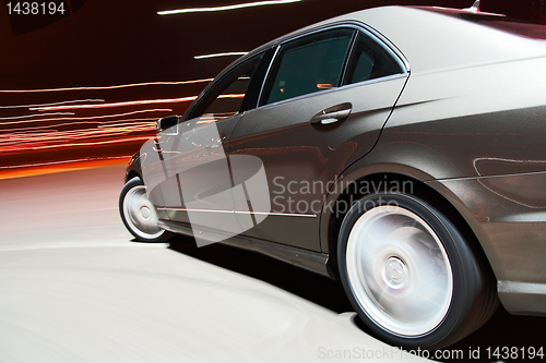 Image of Side view of a car driving fast