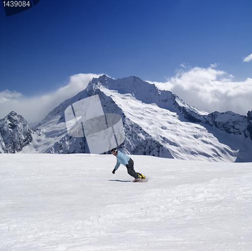 Image of Snowboarder in high mountains