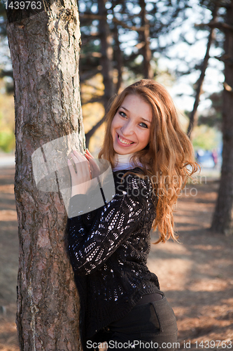 Image of Portrait of a girl leaning on the tree