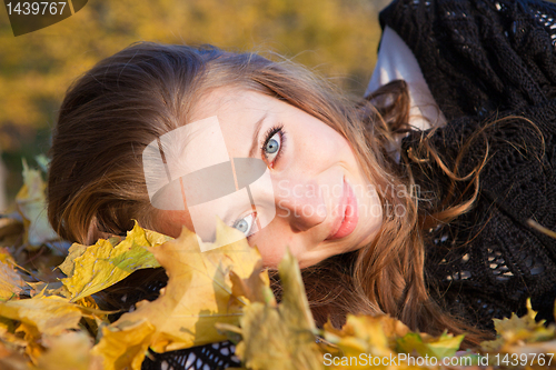 Image of Girl lying in leaves
