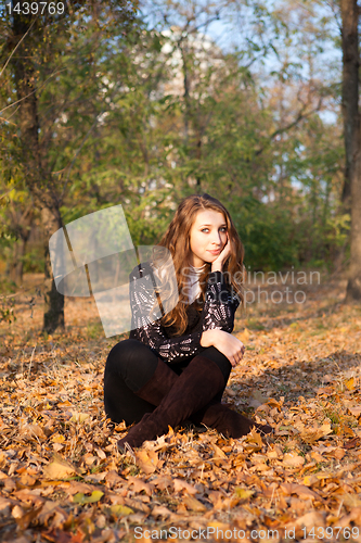 Image of Girl sitting in leaves