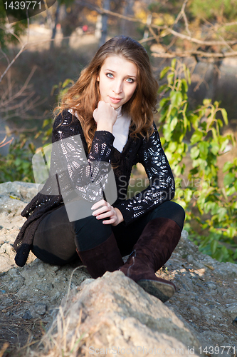 Image of Girl sitting on a stones