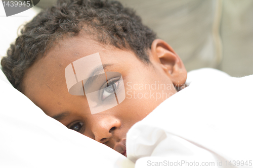 Image of Boy resting in his bed