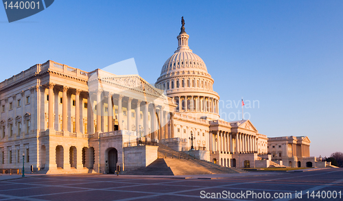 Image of Rising sun illuminates the front of the Capitol building in DC