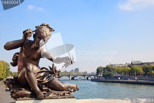 Image of Small child statue frames view of Seine and Paris