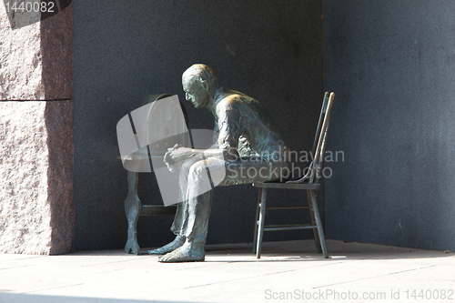 Image of Statue of poor man listening to radio